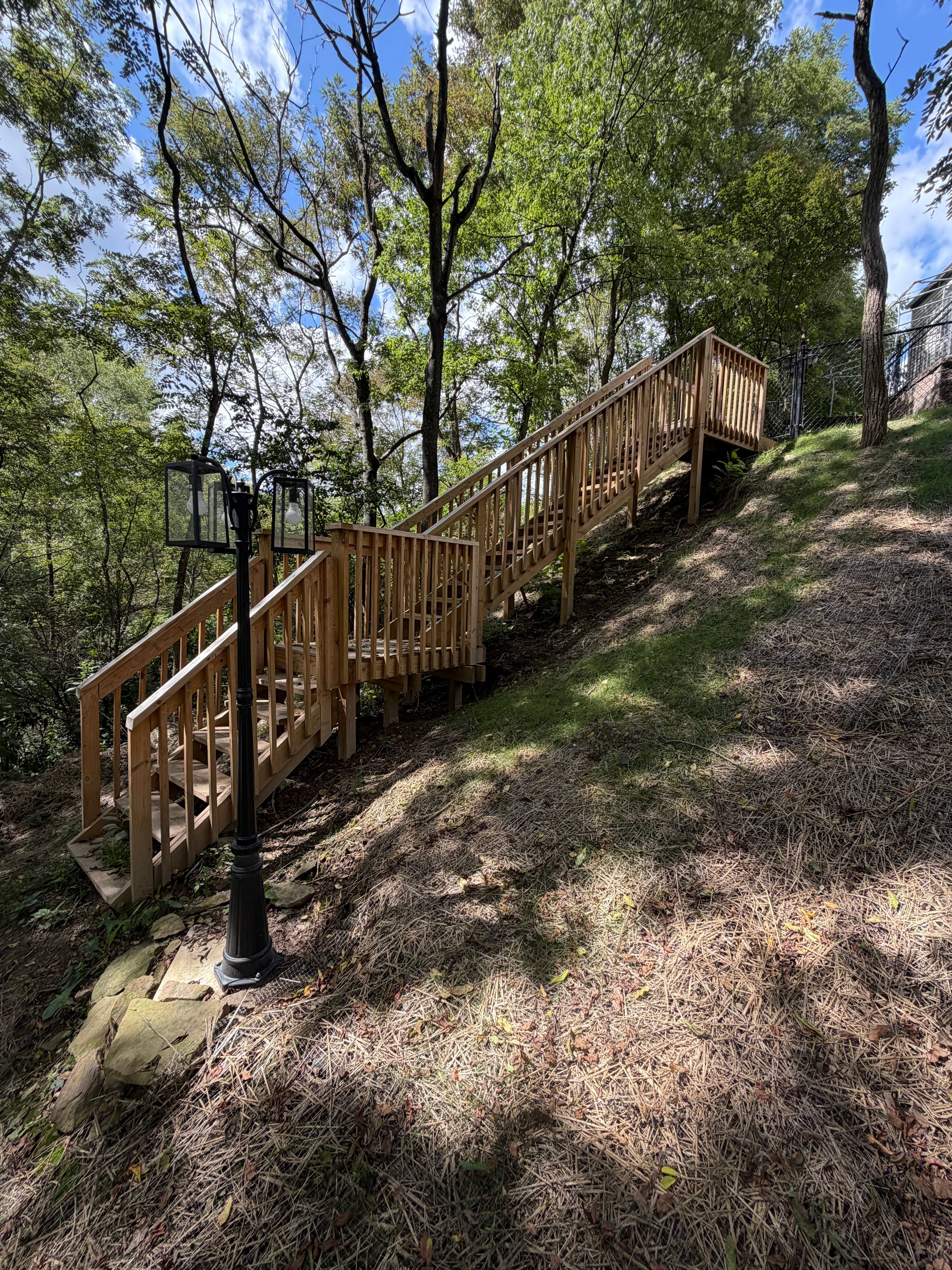 Wooden staircase climbing a wooded hillside